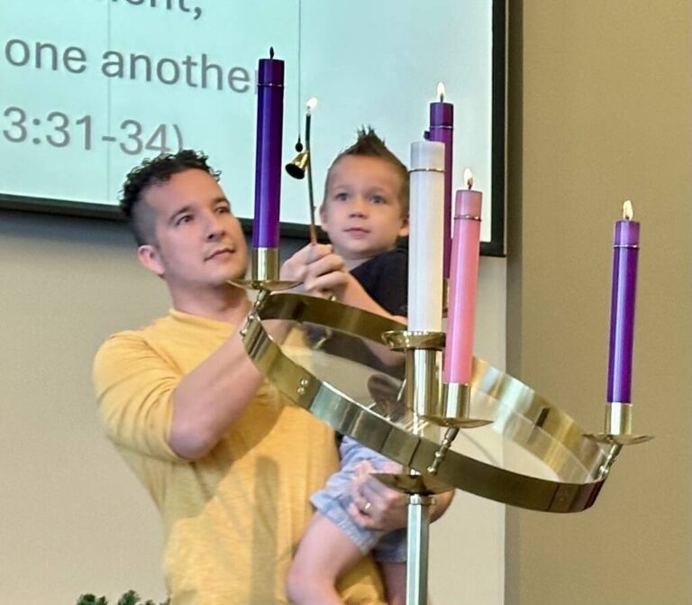 Father and son lighting the Advent Candle